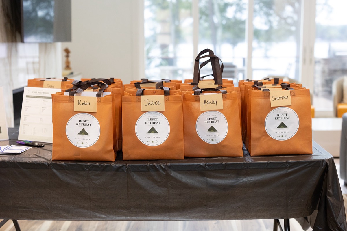 Reset Retreat welcome bags lined up on a table