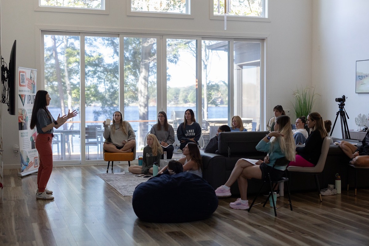 A workshop in the living room with the lake behind the windows