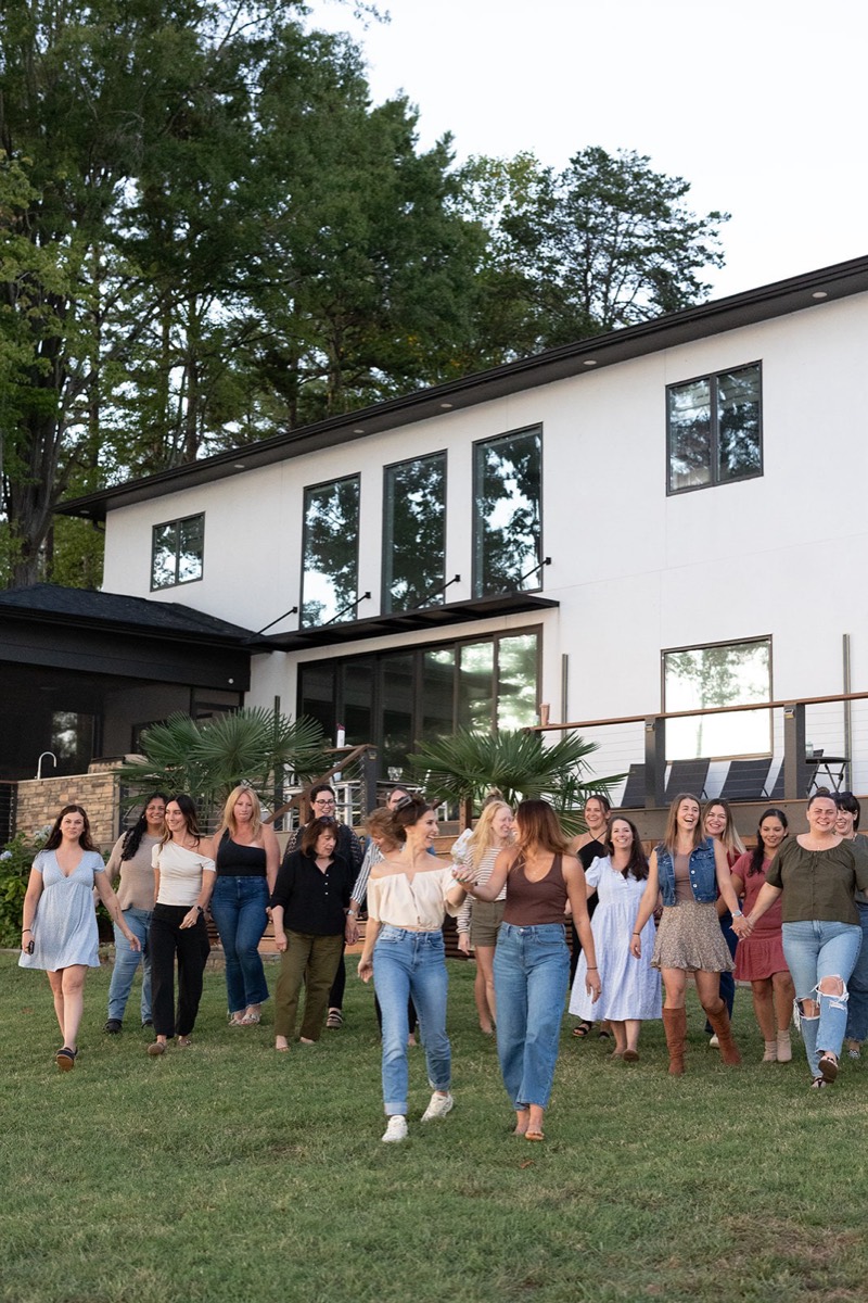 The Reset Retreat group on the lawn in front of the lake house